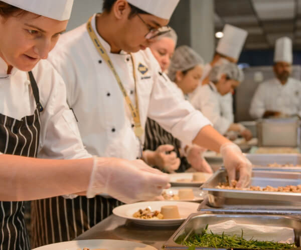 Chef's preparing food for a stadium restaurant