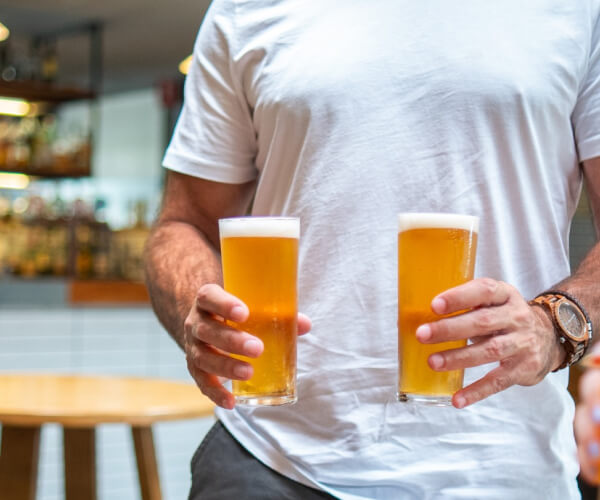Man with beers at a pub