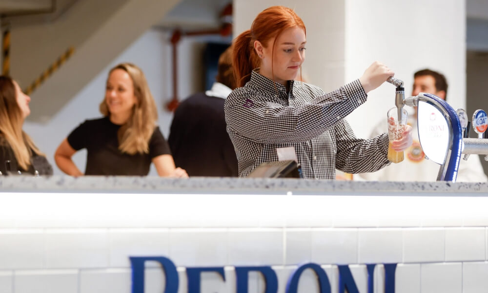 Bar staff pouring a beer at a Marvel Stadium bar