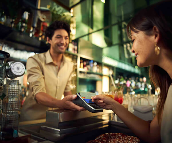 Women paying with Oolio Pay at the bar
