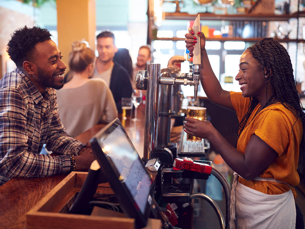 Bar staff pouring a beer at the pub