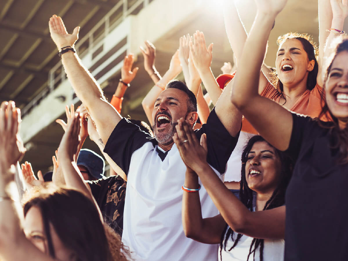 Excited fans in the stand of a stadium