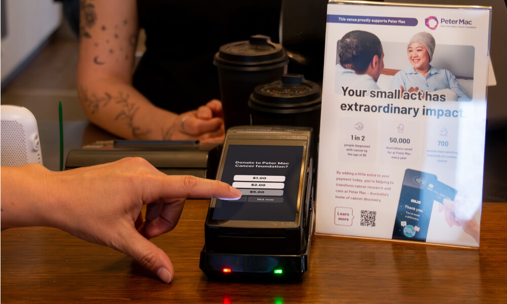 EFTPOS Terminal with donation screen and peter mac flyer