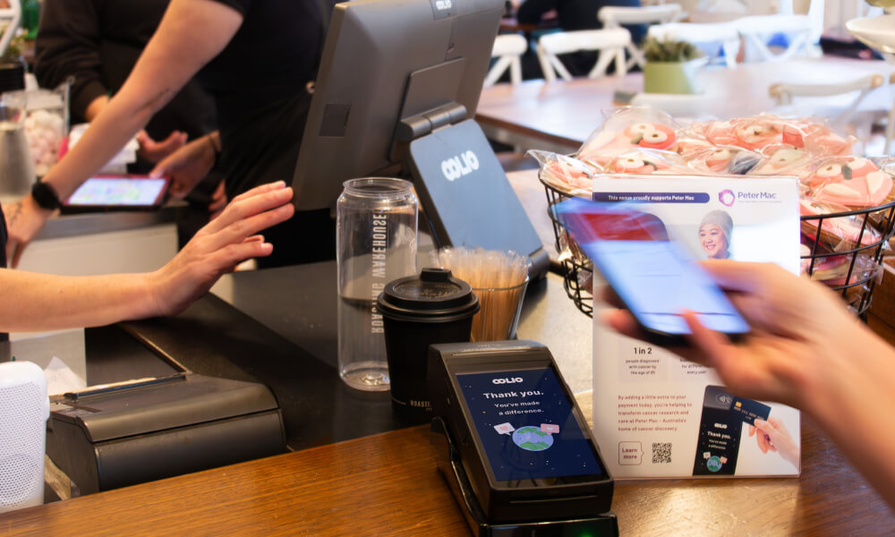 Customer paying on EFTPOS terminal with Oolio Giving Donation screen