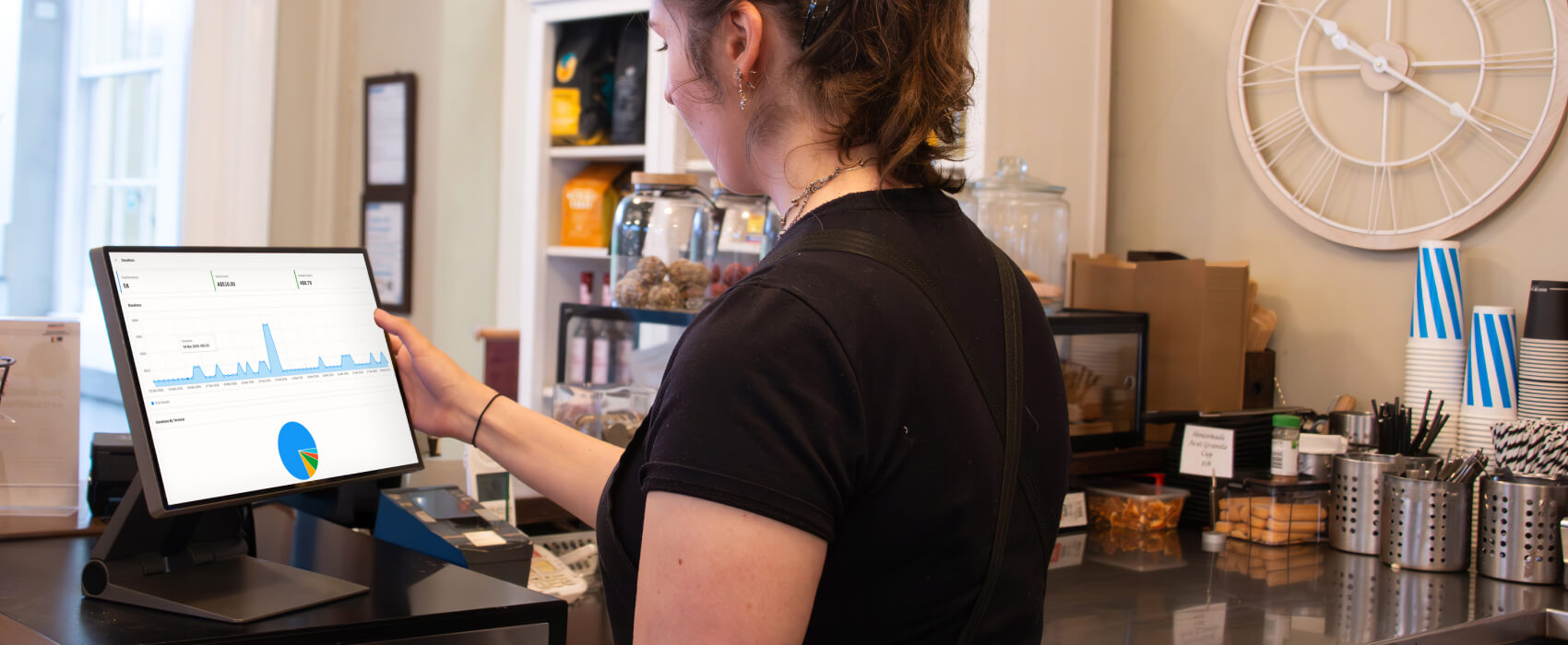 Image of cafe staff on Oolio POS looking at reporting