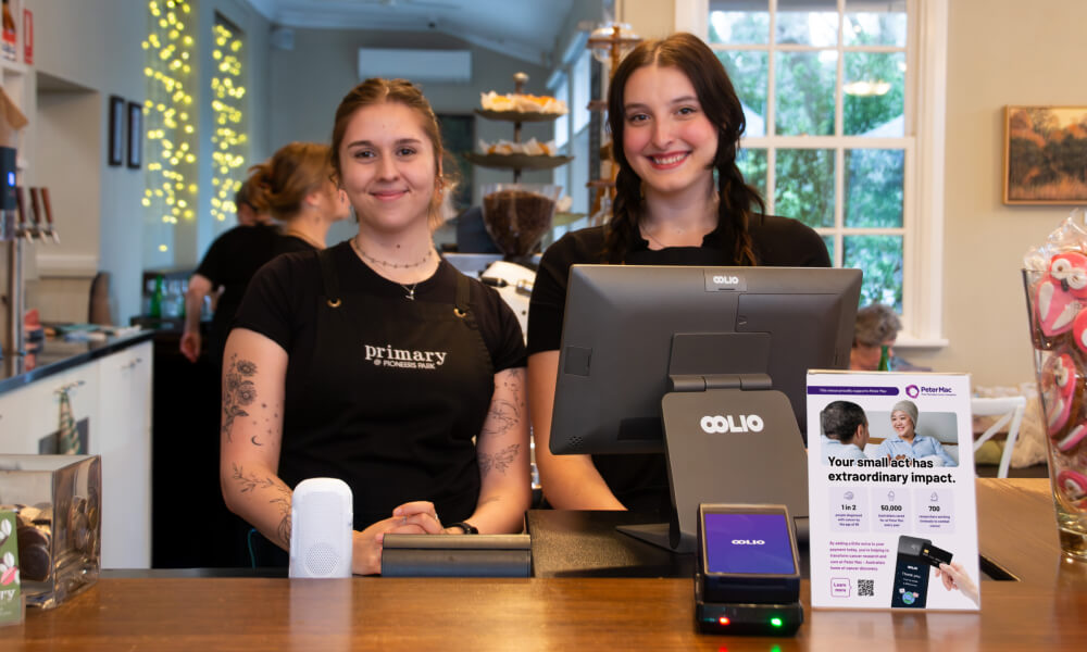 Happy staff in a cafe with Oolio POS and payments and Oolio Giving