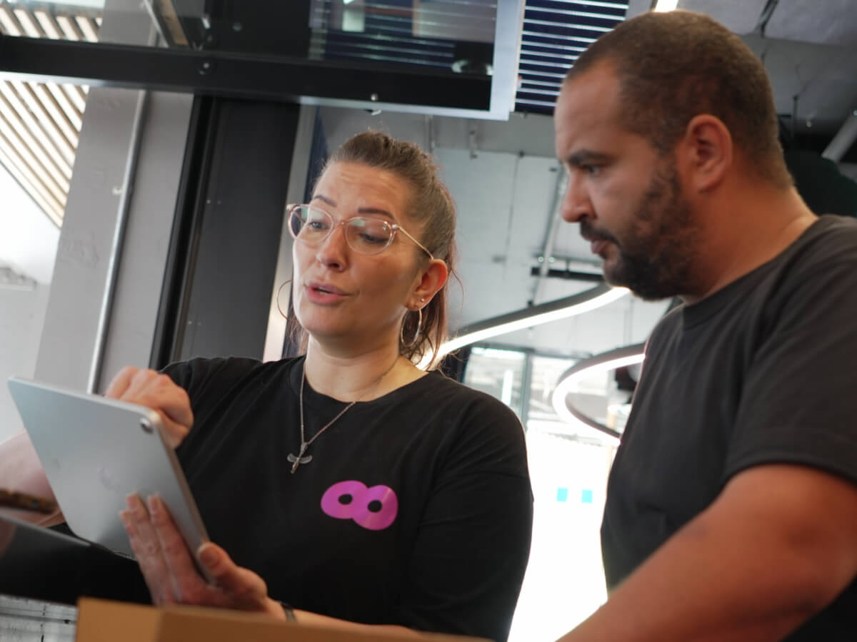 Oolio team member training venue owner using new hospitality tech