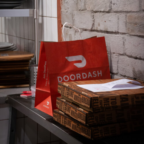 Delivery bag and pizza box in shop