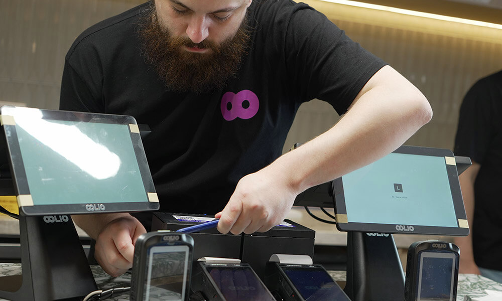 Oolio team member installing POS system
